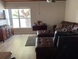 Living room with couch and large window.