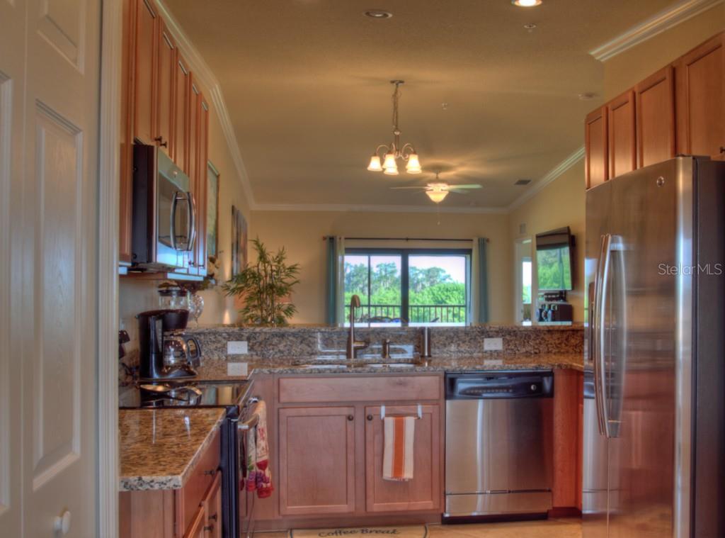 Modern kitchen with stainless steel appliances.