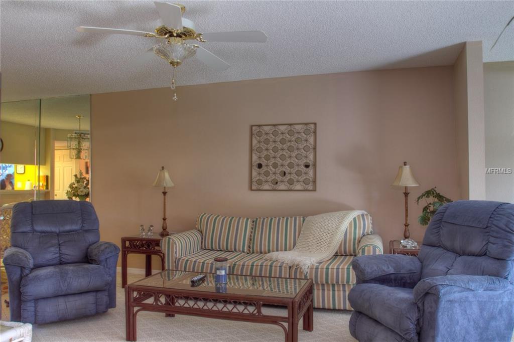 Living room with striped couch and two armchairs.