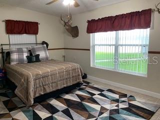 A bedroom with a bed and a rug.