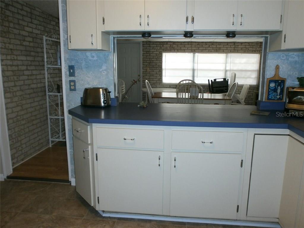 White kitchen cabinets with blue countertop.