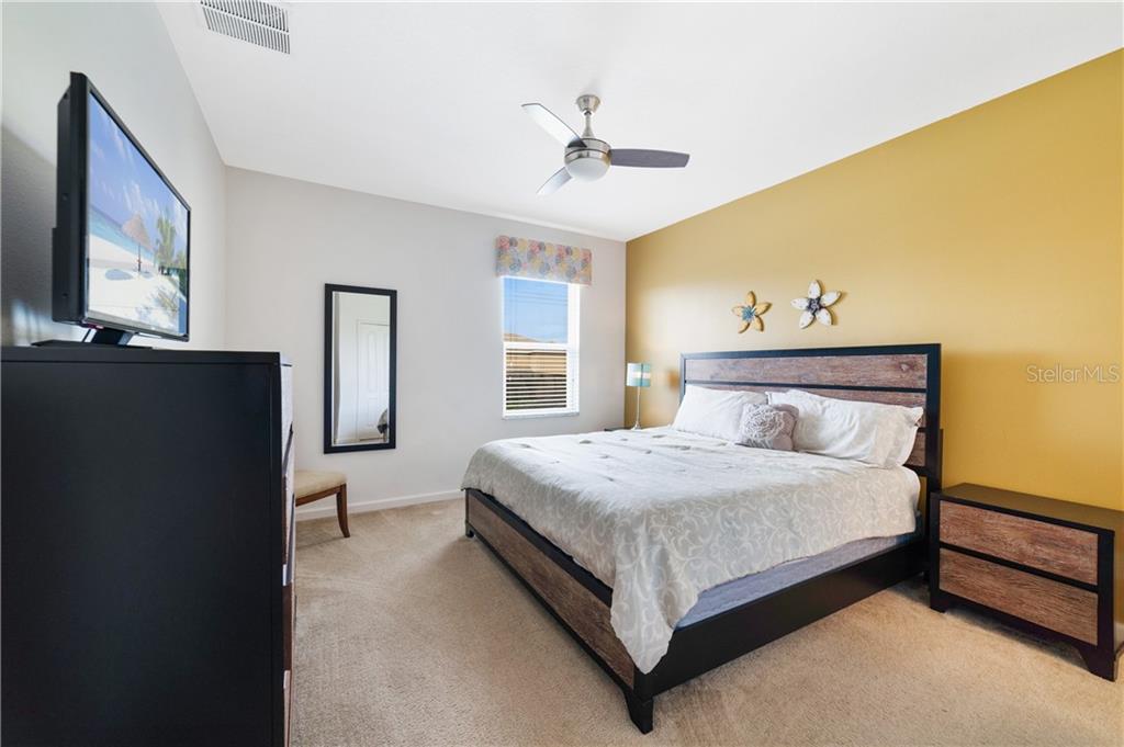 Bedroom with a large bed and TV.