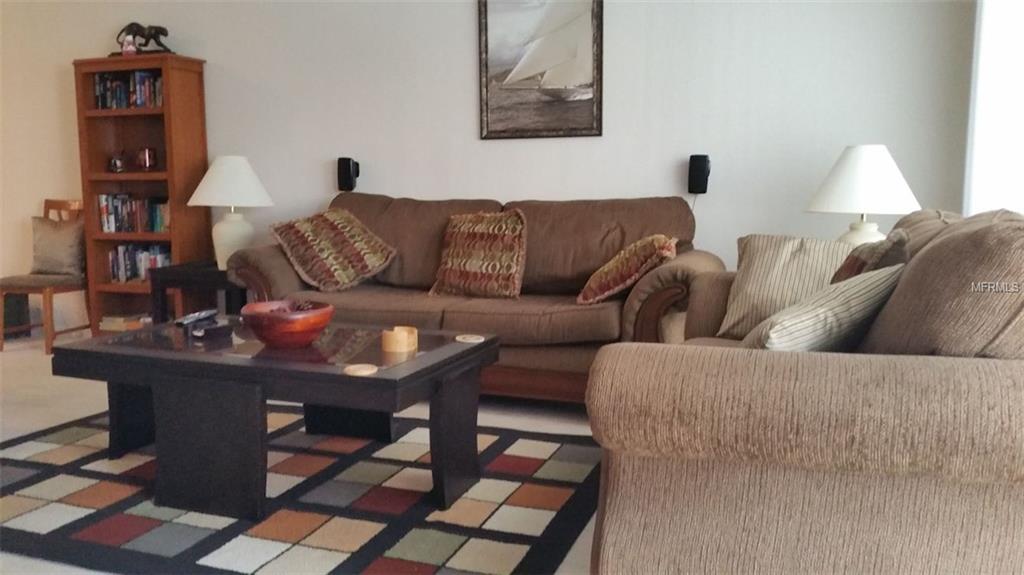 Living room with brown couches and a coffee table.