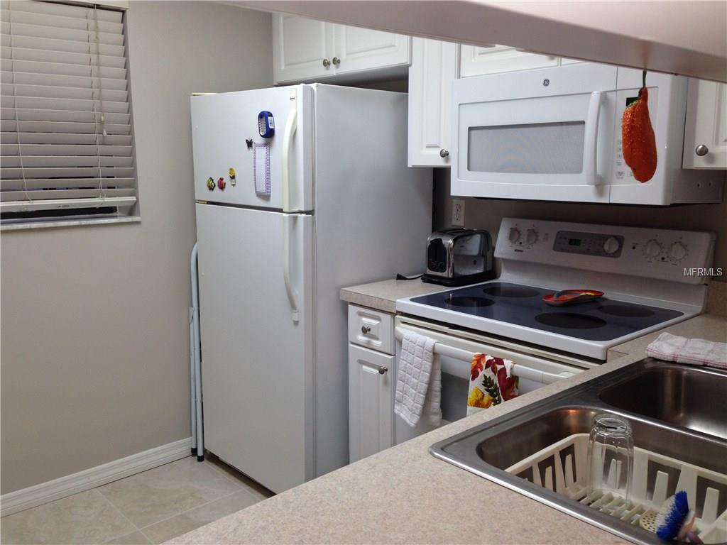 White kitchen with stainless steel appliances.