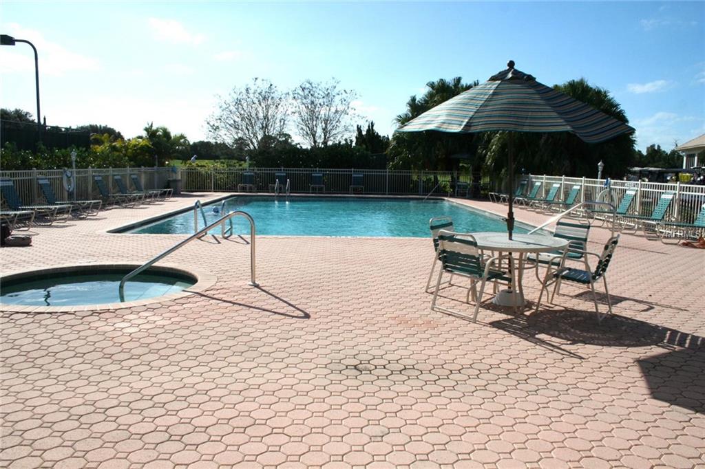 Outdoor pool area with patio furniture.