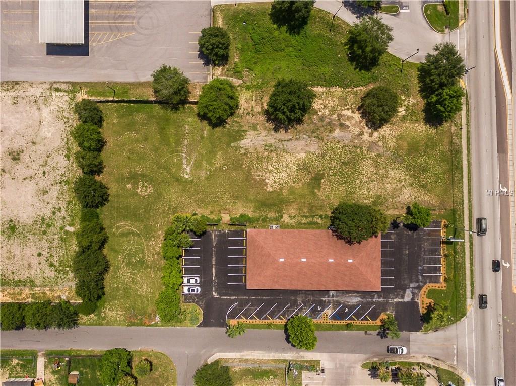 Aerial view of a vacant lot with a building.