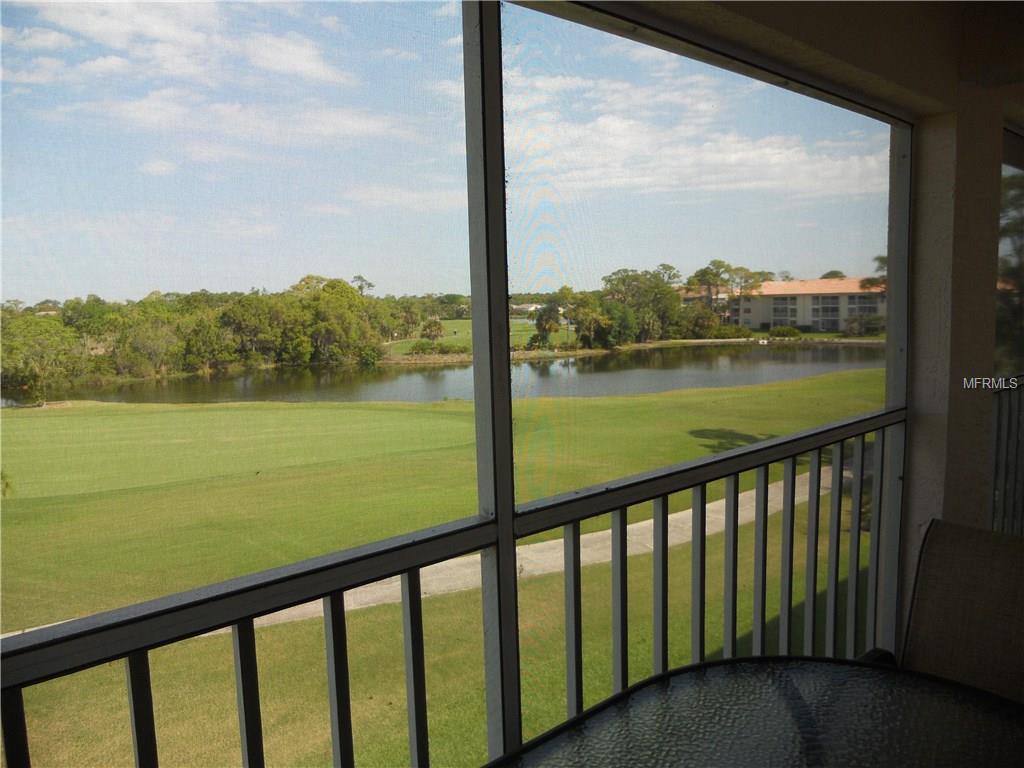 View of a golf course with a pond.