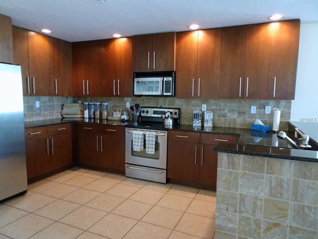 Modern kitchen with stainless steel appliances.