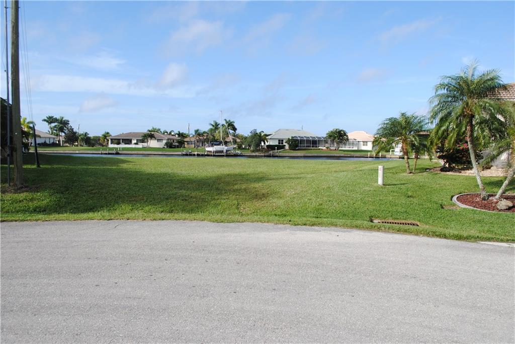 Empty lot with green grass and canal view.