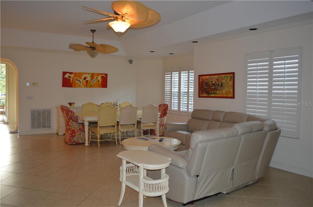 Living room with sectional sofa and dining table.