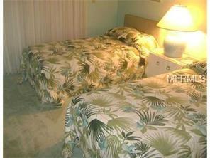 Two twin beds with floral patterned bedding.