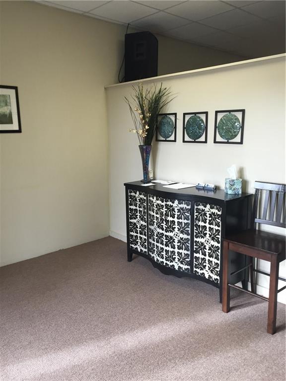 Black cabinet with floral pattern in a room.