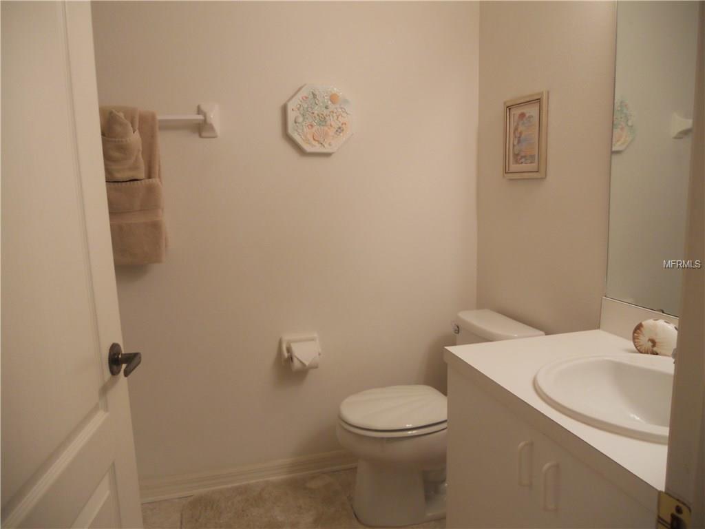 White bathroom with toilet and sink.