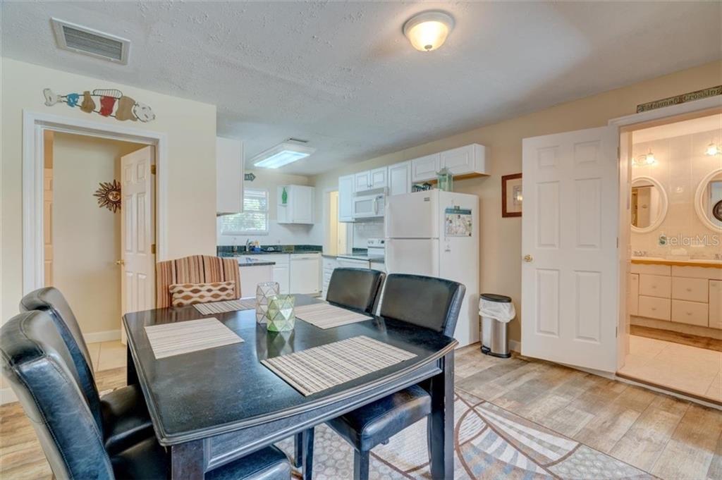 Dining room with black table and chairs.