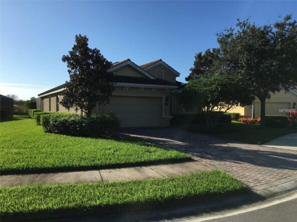 Single-story house with a brick driveway.