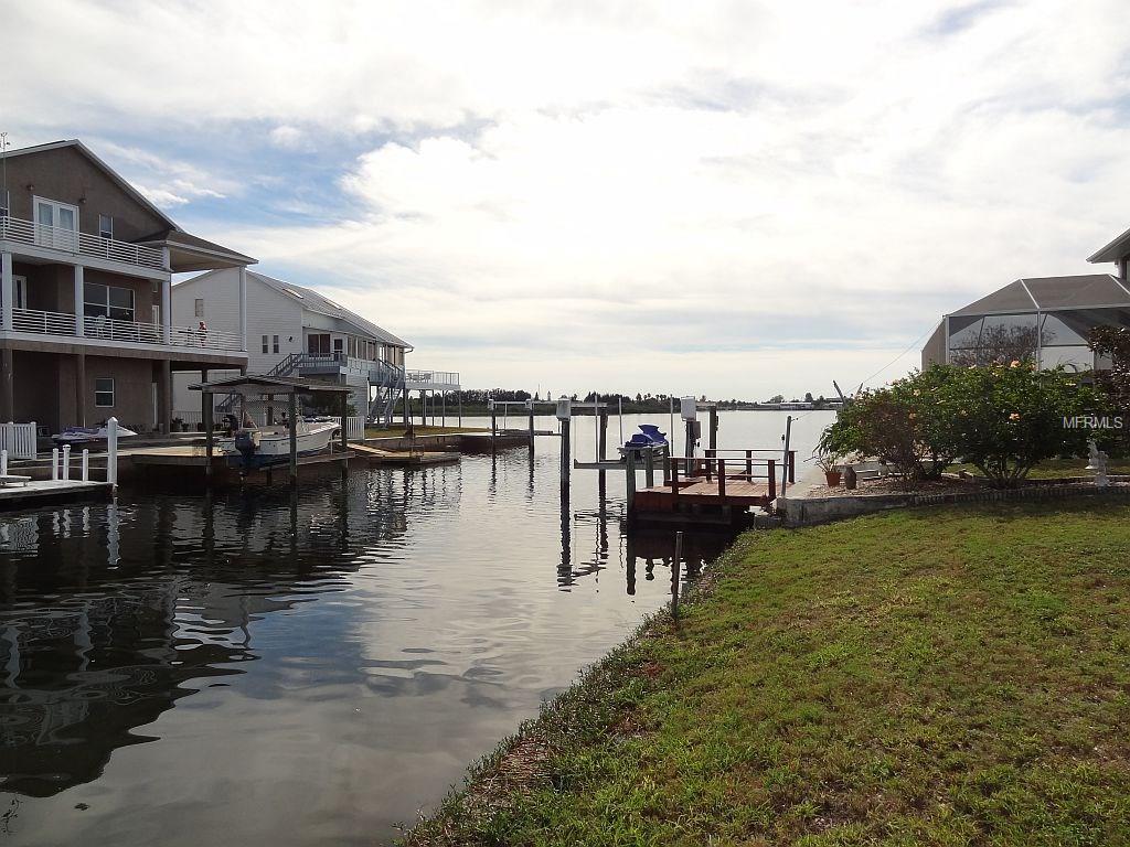 A canal with a boat dock and houses.