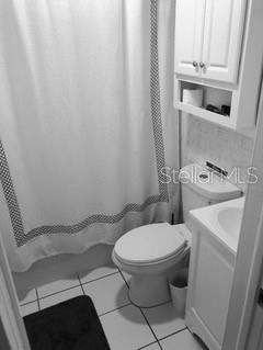 A white bathroom with a toilet and sink.