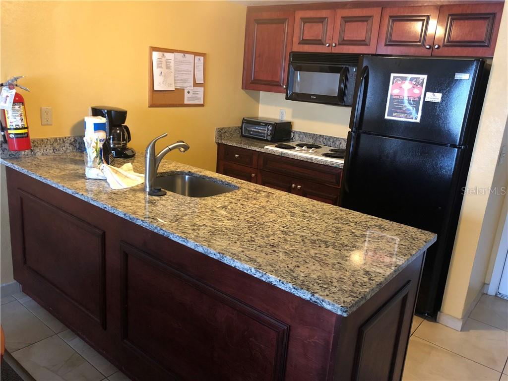 Kitchen with granite countertop and stainless sink.