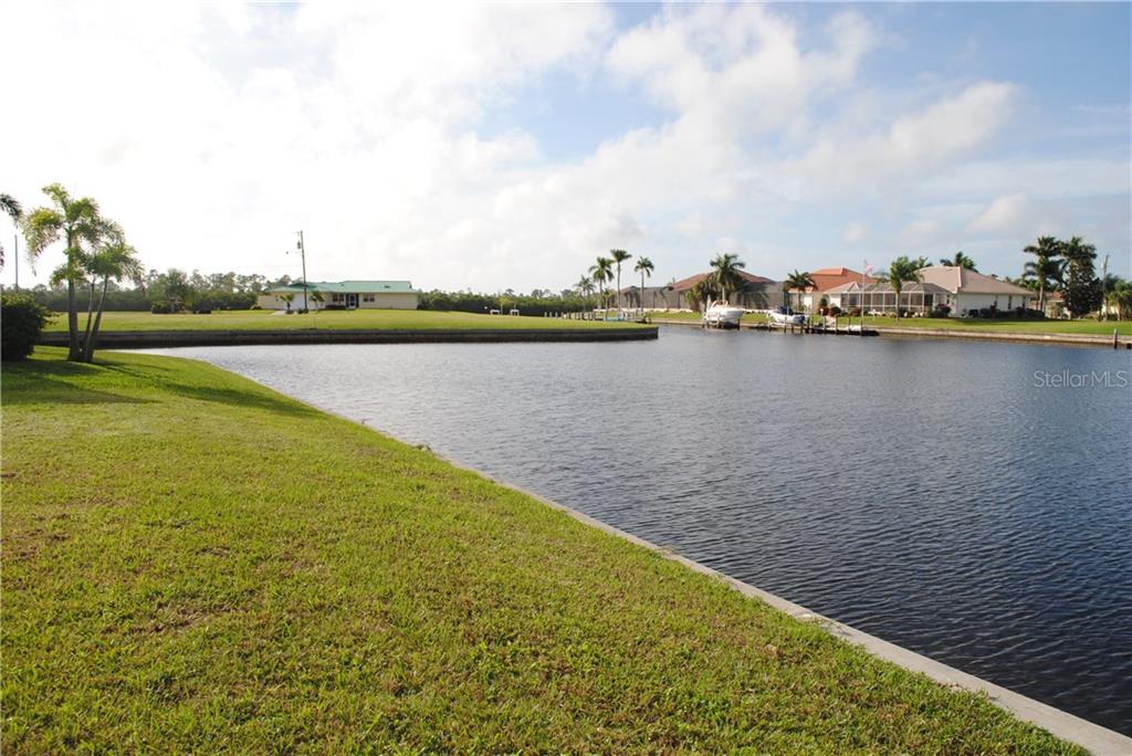 Waterfront view with houses and boats.