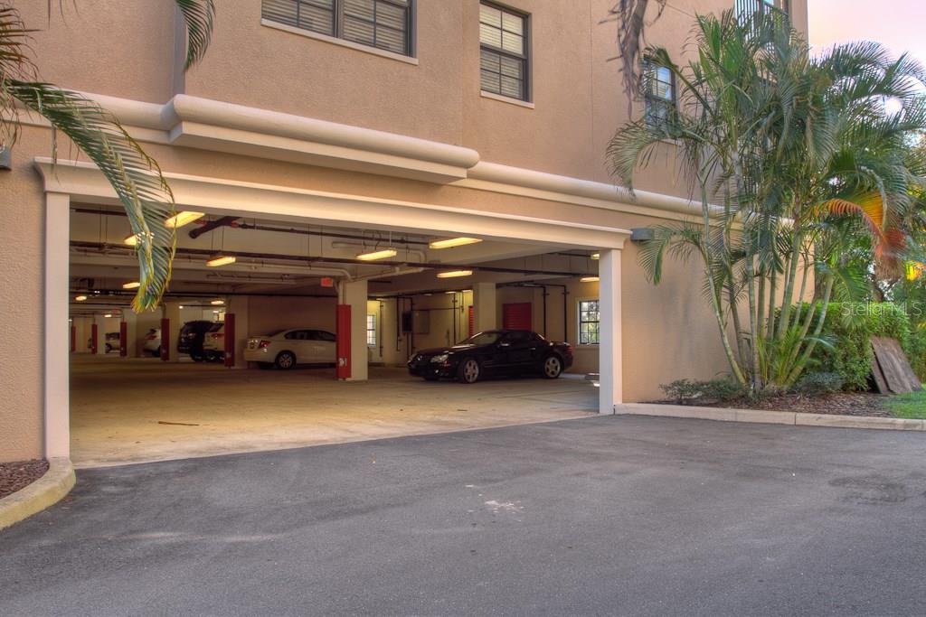 Garage entrance with cars parked inside.