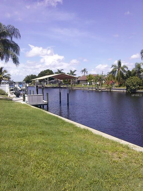 Waterfront property with a dock and grass.