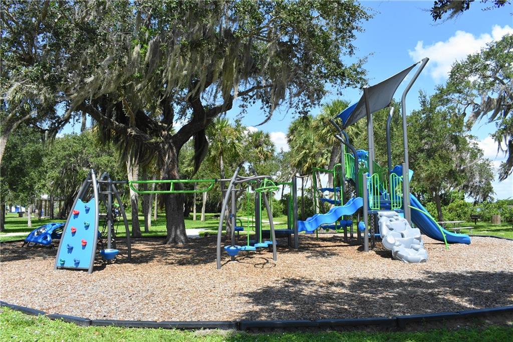 Blue and green playground equipment in park.