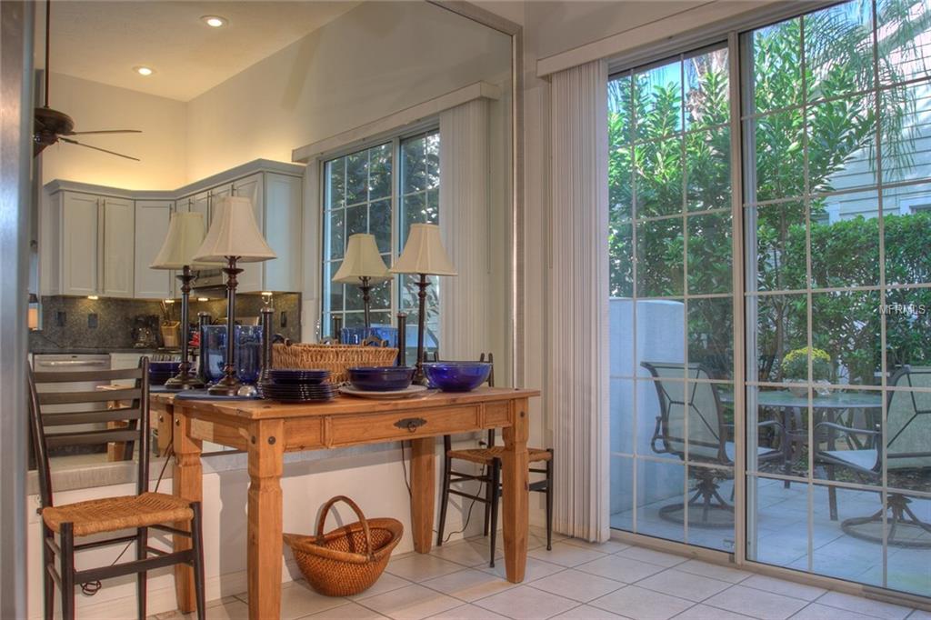 Dining table with chairs and patio view.