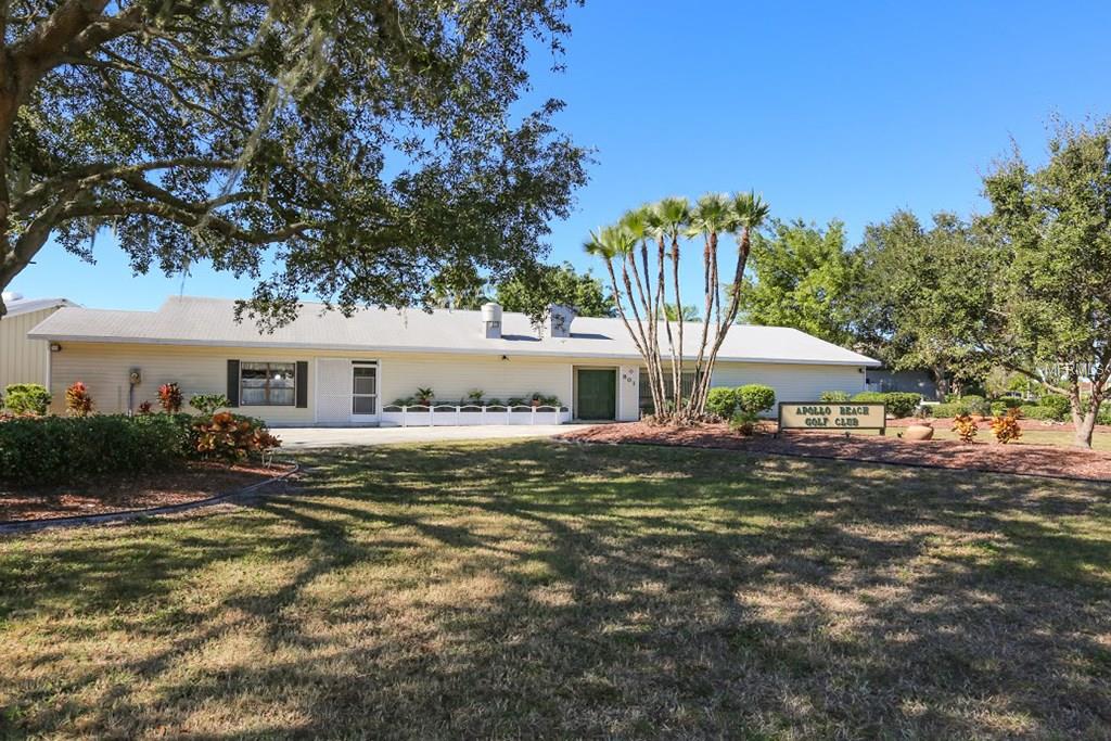 Apollo Beach Golf Club building with palm trees.