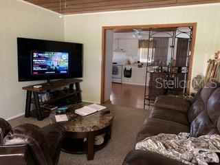 Living room with a couch and TV.