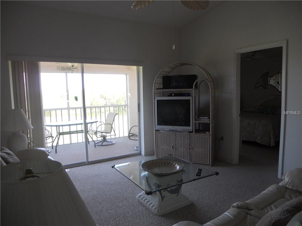 Living room with TV and balcony view.