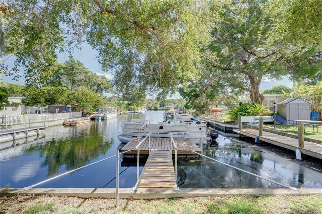 Wooden dock with boats on canal.