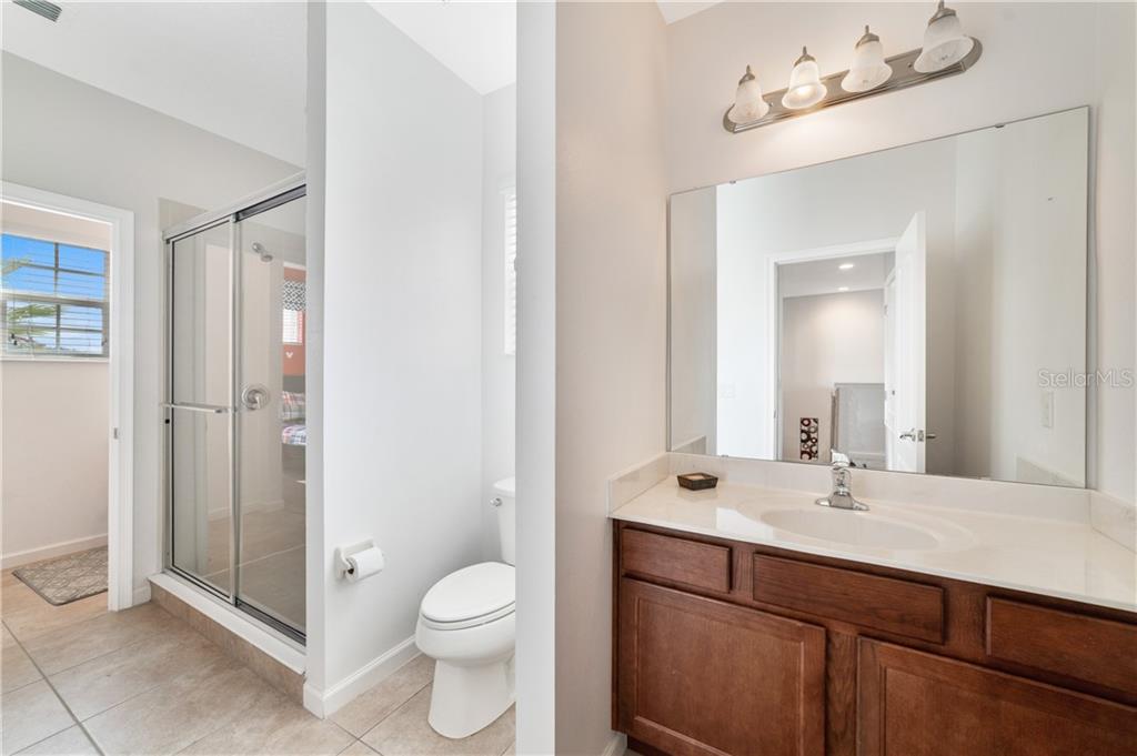 Modern bathroom with a white toilet and vanity.