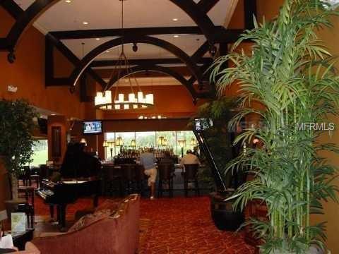 Grand piano and plants in a restaurant.