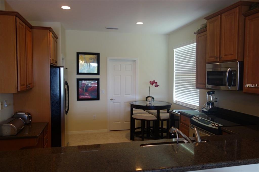 Modern kitchen with stainless steel appliances.