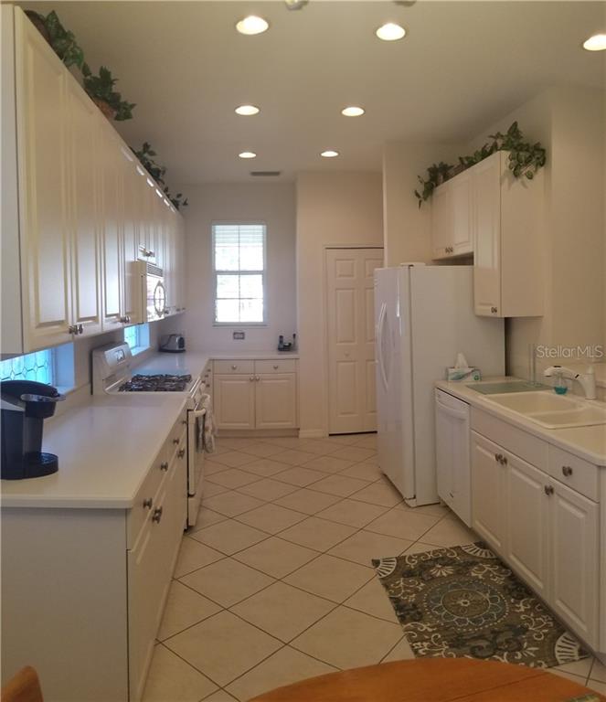 White kitchen with stainless steel appliances.