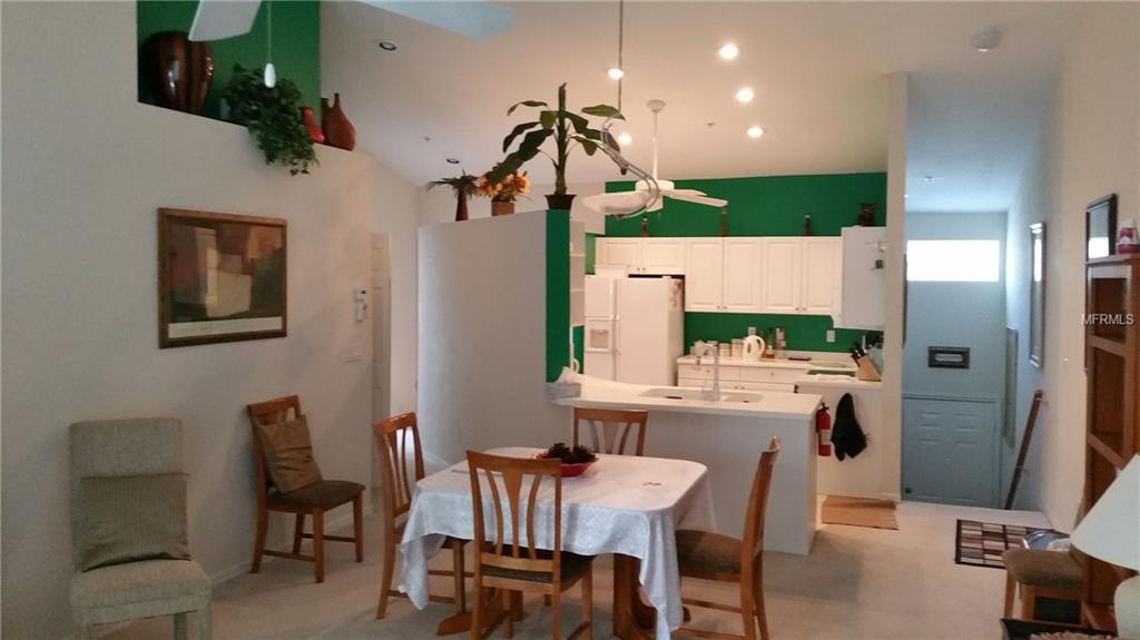 Kitchen and dining room interior with white cabinets.