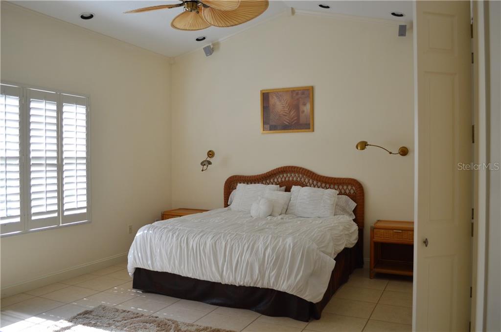 White bed in a well-lit bedroom.