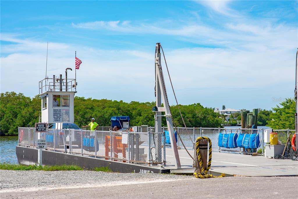 A ferry dock with a car waiting.