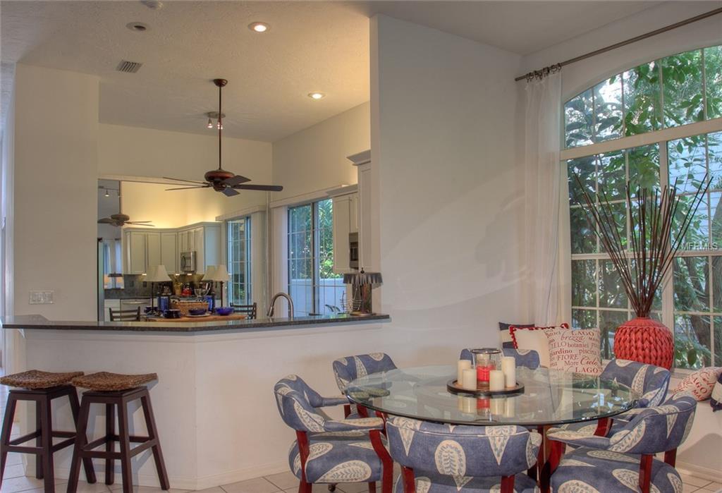 Kitchen and dining area with large windows.