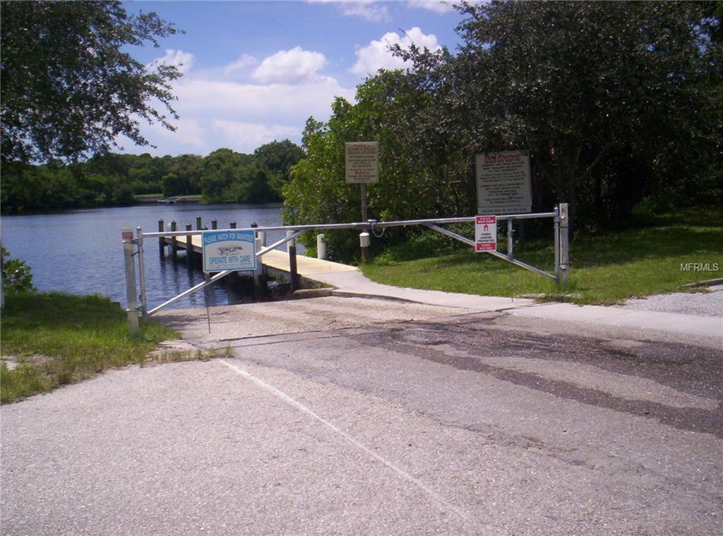 Boat ramp with gate and signs.