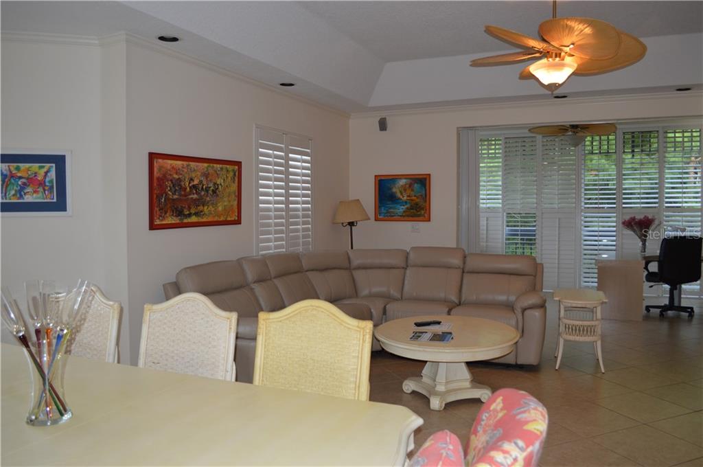 Living room with sectional sofa and ceiling fan.