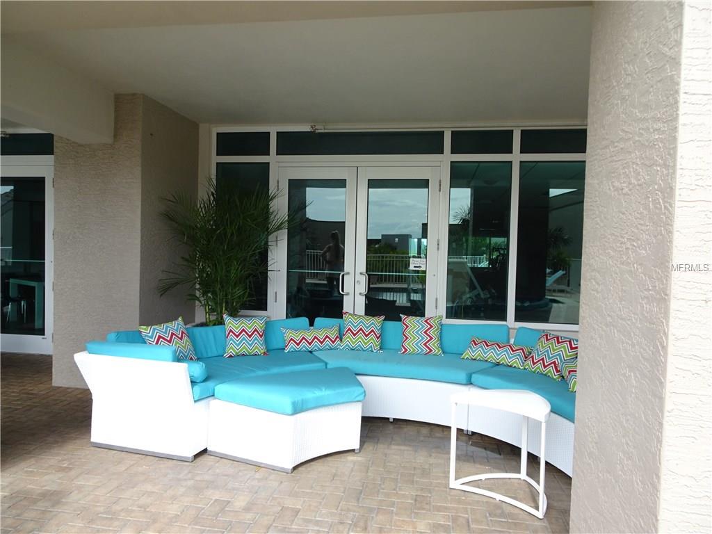 White patio furniture with blue cushions.