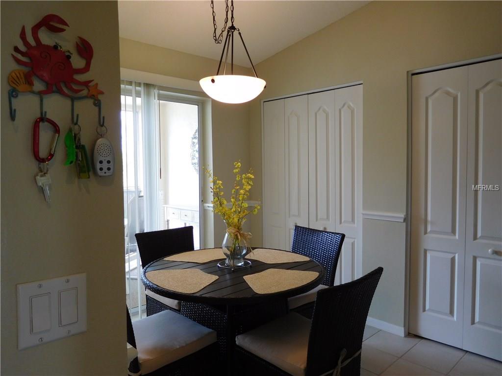 Dining room with table and chairs near sliding doors.