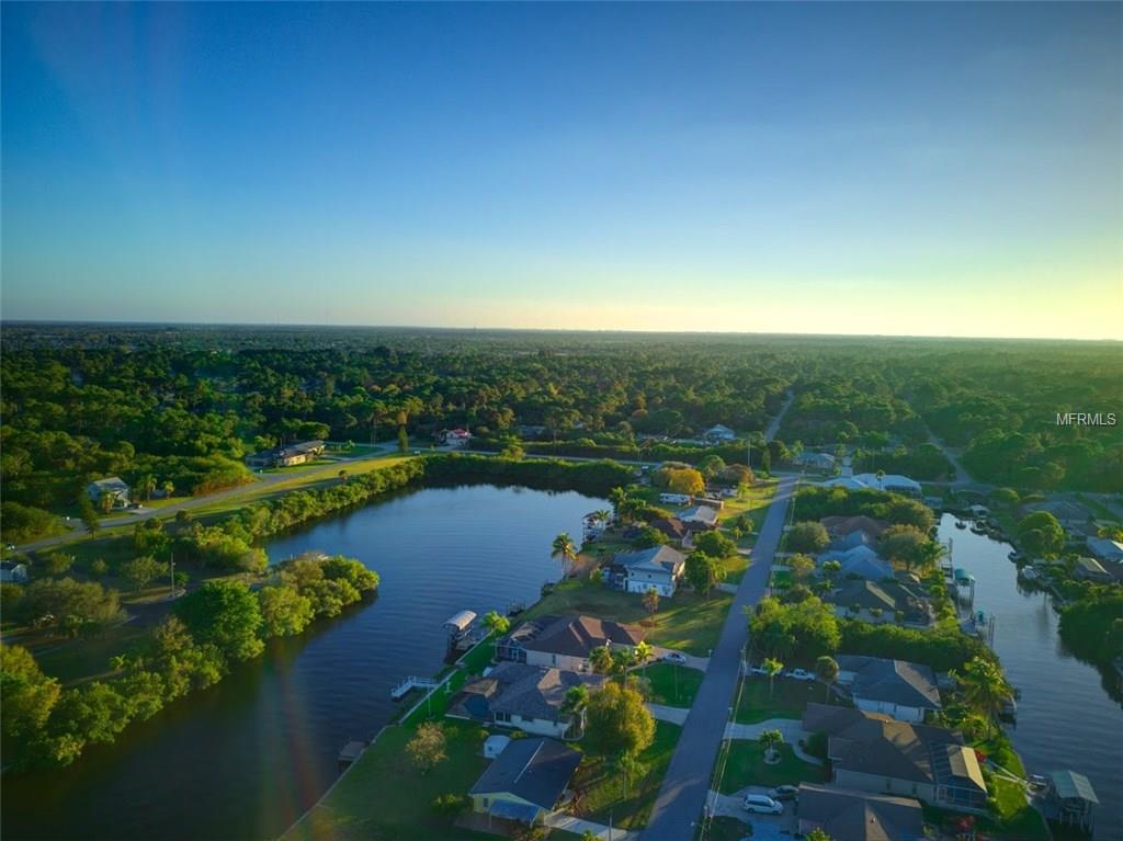 Aerial view of homes by the water.