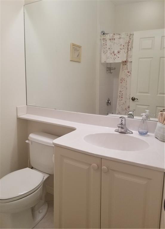 White bathroom vanity with toilet and sink.