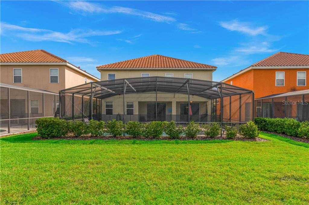 Backyard view of a house with a pool.