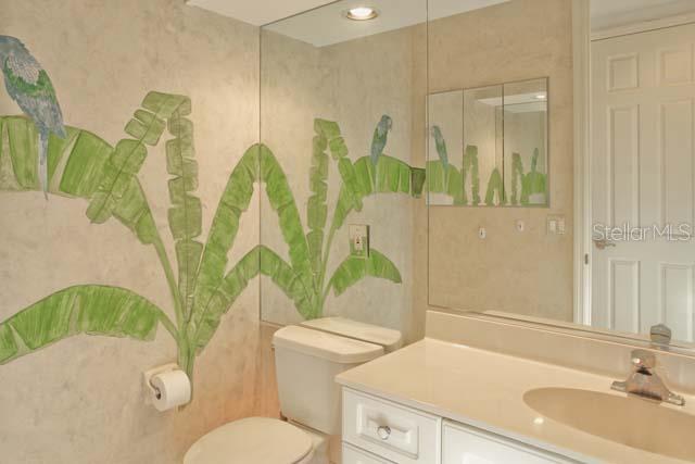 Tropical bathroom with toilet and sink.