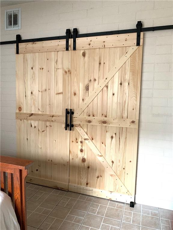 Two wooden sliding barn doors with black hardware.