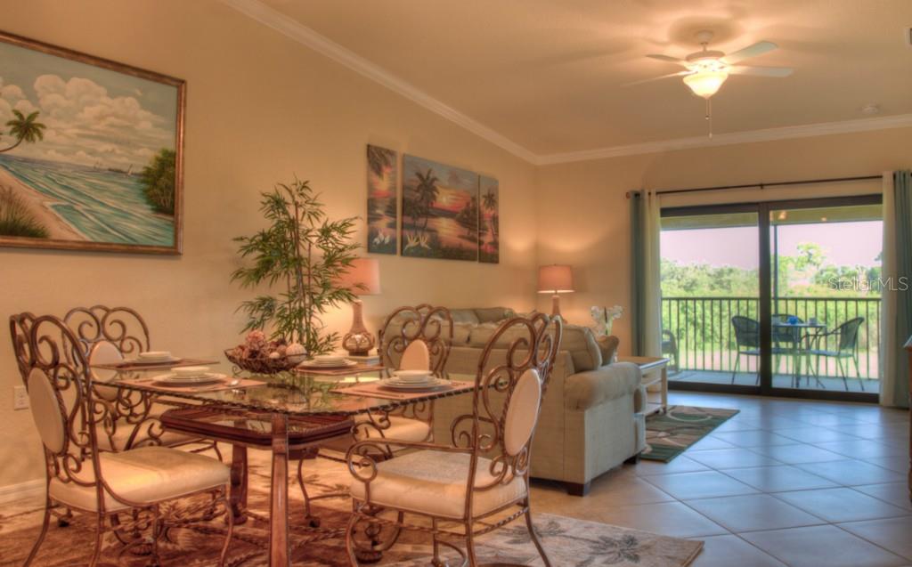 Dining room with glass table and patio view.