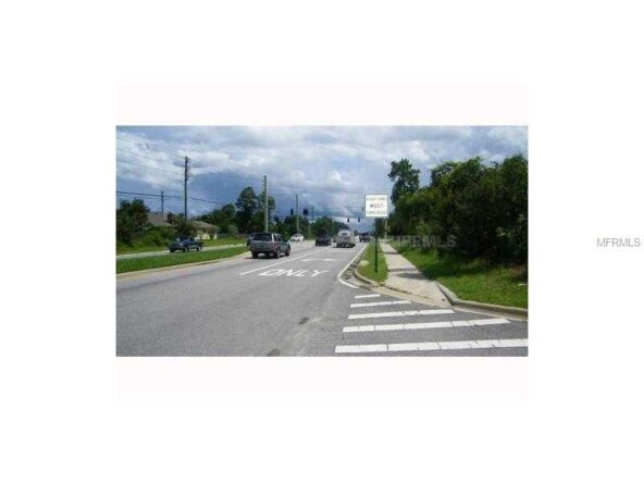 Road with crosswalk, left turn only sign.